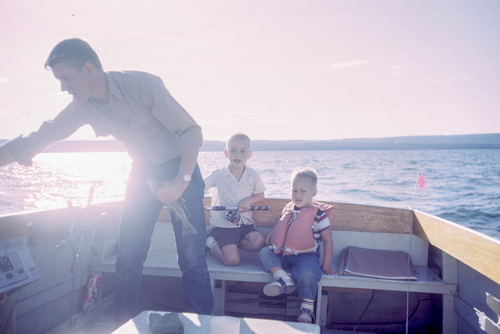 Family launching a boat at a solar-lit boat ramp