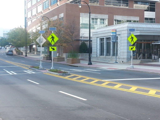 Solar pedestrian crosswalk with flashing beacon and push button